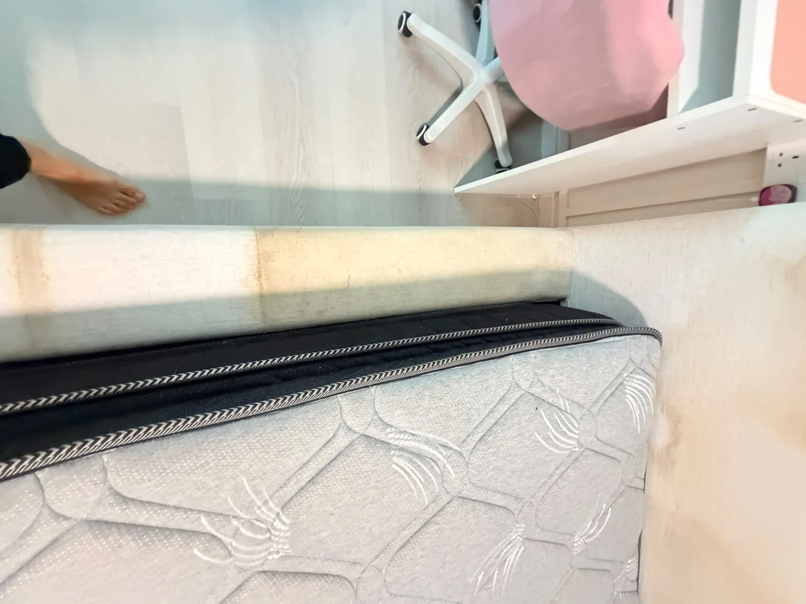 Mattress before deep cleaning โ visible staining along the edge