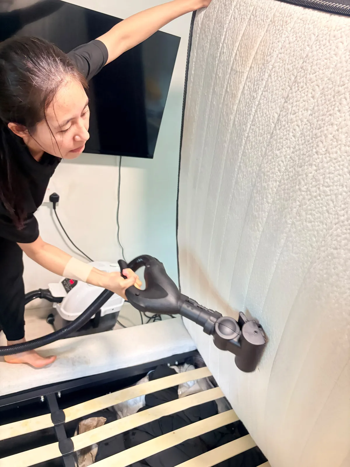 Mattress deep cleaning in progress โ extraction tool treating side panel