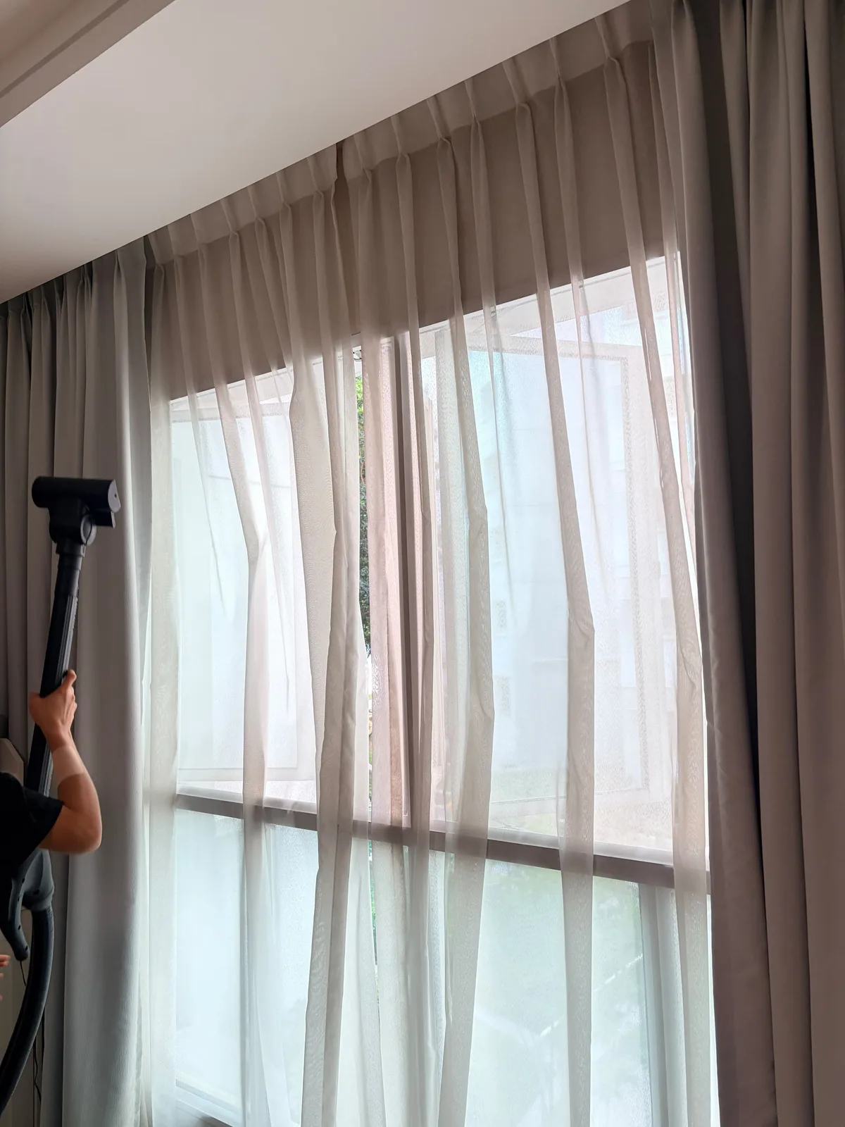 Curtain deep cleaning in progress โ full-length extraction treatment