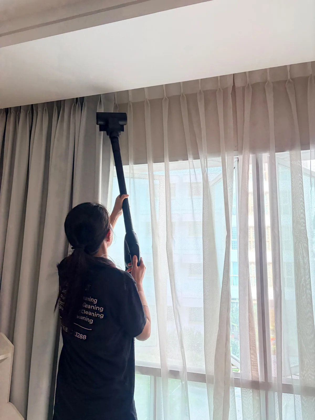 Curtain deep cleaning โ upper section treated with extraction tool