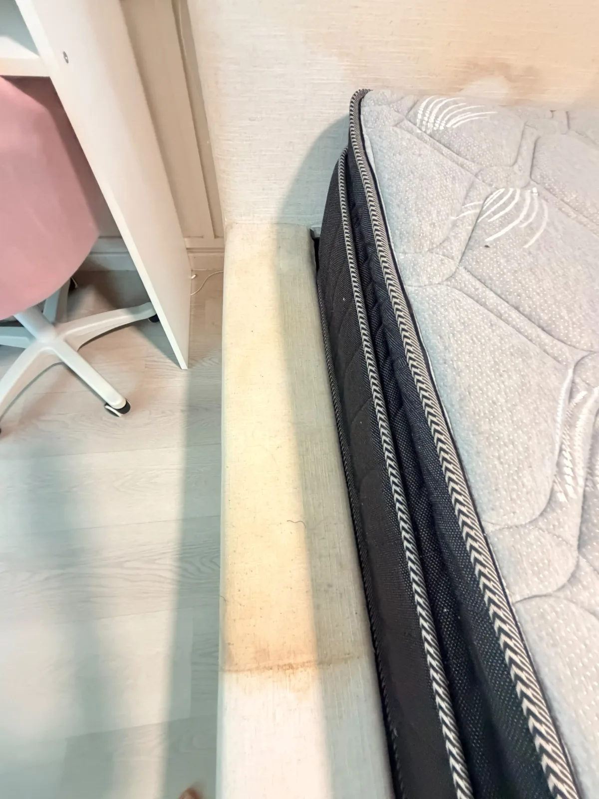Mattress before deep cleaning โ stained edge and bed base detail