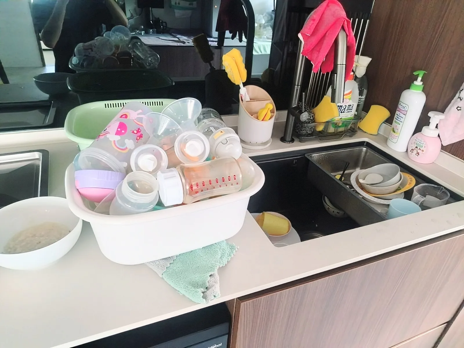 Live-out helper cleaning kitchen