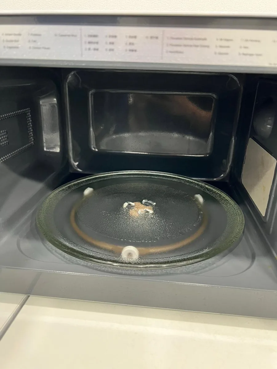 Office microwave before cleaning — grease and buildup inside