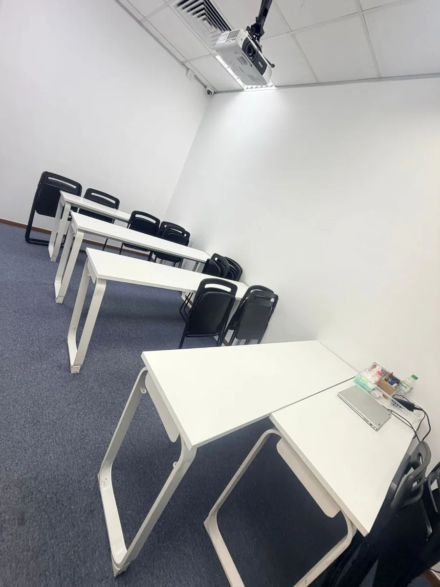 Clean training room result — white tables and carpeted floor