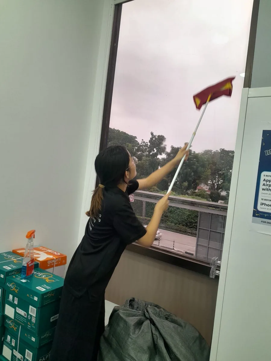 High window cleaning with long pole — reaching every pane