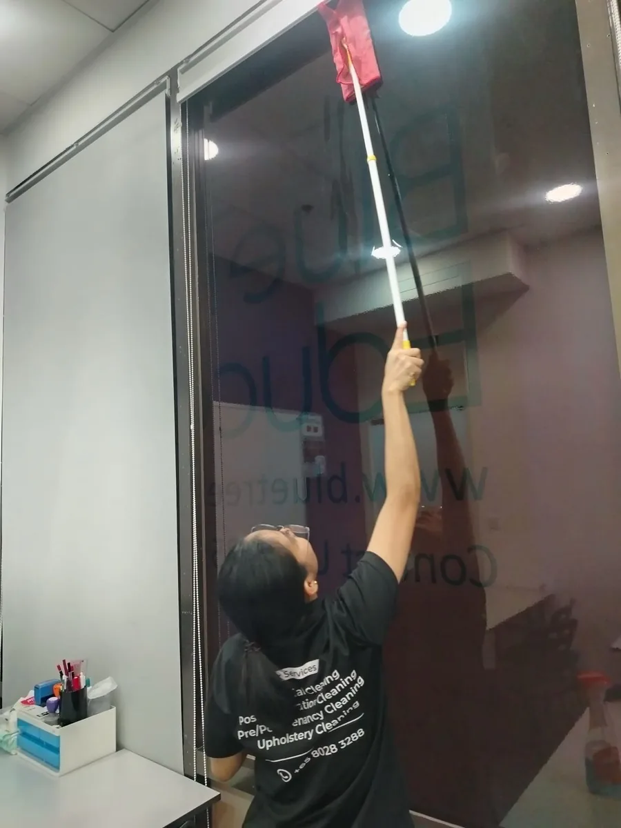 Office glass partition cleaning with long-reach tool