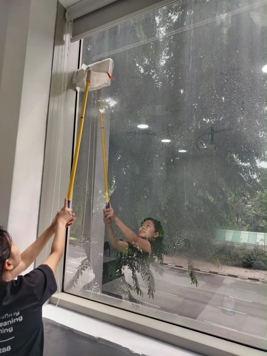 Office window cleaning with long pole